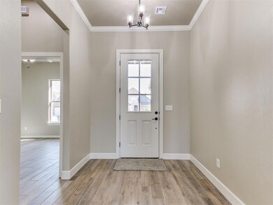 Foyer entrance with a notable chandelier, ornament