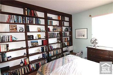 Second bedroom has built-in bookshelves.