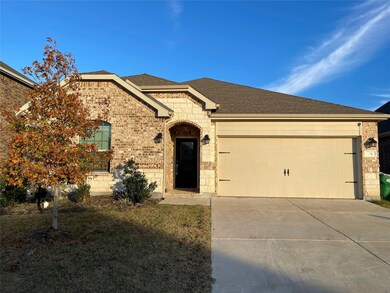 View of front of property with driveway, brick siding, a garage, and roof with shingles