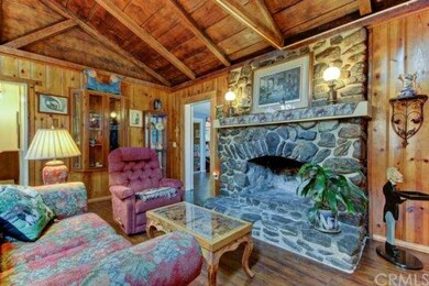 Original river rock fireplace makes for a cozy amb