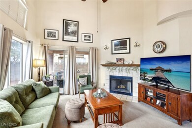 Carpeted living area featuring a high ceiling, a f