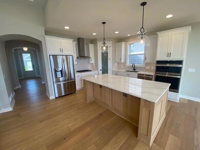 Your brand new home with warranties! Custom Cabinetry: Gourmet kitchen with gas cooktop, built-in wall microwave/oven, , stainless steel hood, corner pantry, and large center island with extra storage.