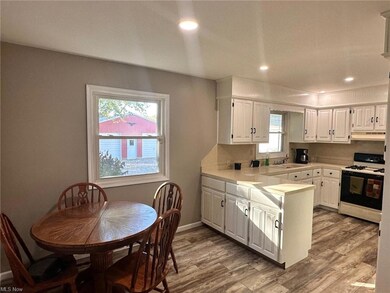 Kitchen featuring light wood-type flooring, white 