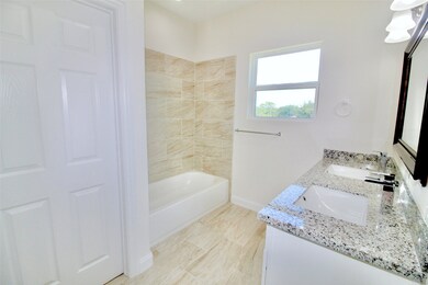 Primary bath has tub/shower combo and dual sink va