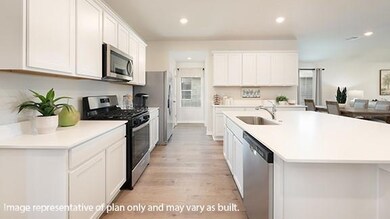 Kitchen with appliances with stainless steel finishes, a center island with sink, white cabinets, light wood-style flooring, and recessed lighting