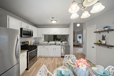 Ditch the takeout and cook from home more often! The kitchen is beautifully appointed with white cabinetry, granite countertops, subway tile backsplash, and modern stainless steel appliances.