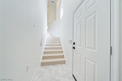 Foyer. Brand new carpeting leads upstairs to the m