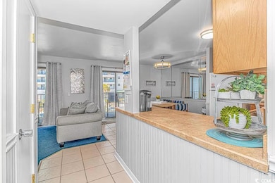 Kitchen featuring open floor plan, light counterto
