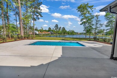View of pool with a water view, a patio, fence, an
