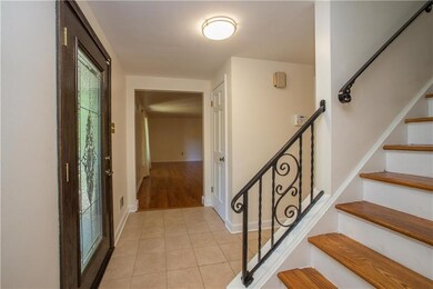 The foyer is tiled and offers a guest coat closet 