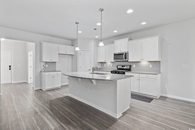 Kitchen with light stone counters, stainless steel