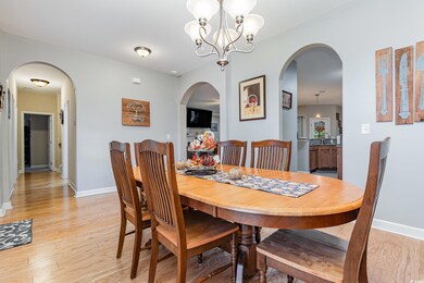 Dining space with sink, a chandelier, and light hardwood / wood-style flooring