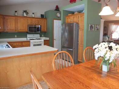 Kitchen has breakfast bar and pantry.