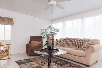 Sun room features easy to clean bright tile floor, cozy up with a book next to your favorite sun loving plants.