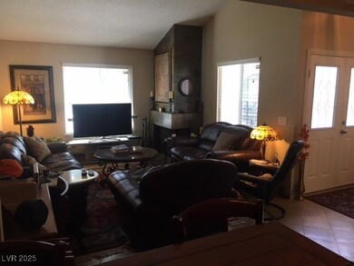 Tiled living room featuring lofted ceiling and ple