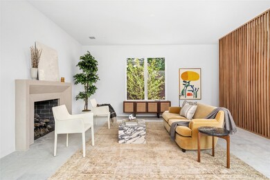 The fireplace and wooden wall create a cozy atmosp