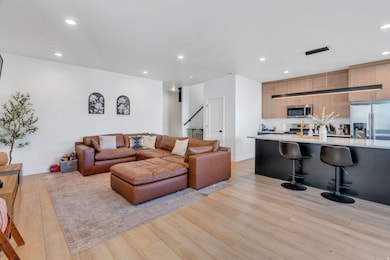 Living room with recessed lighting and light wood-style floors