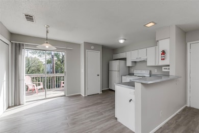Kitchen featuring visible vents, white appliances