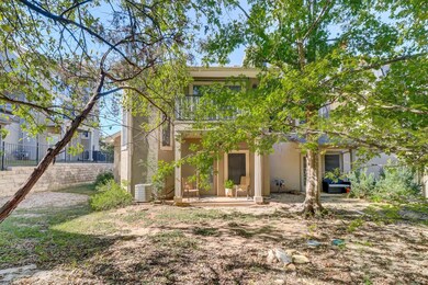 Rear view of house with stucco siding and a patio