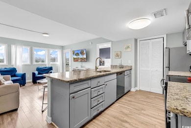 Kitchen featuring light stone counters, a kitchen 