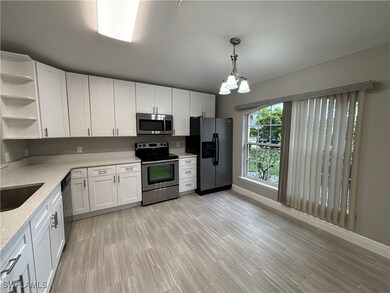 Kitchen with stainless steel appliances, open shel