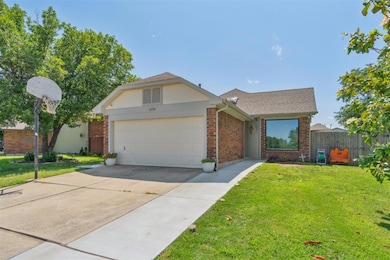 View of front of home with brick siding, a garage, concrete driveway, and a shingled roof