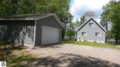 Inside this garage are lake toys. An aluminum fish