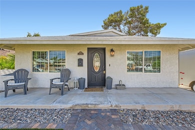 Property entrance featuring stucco siding and a pa