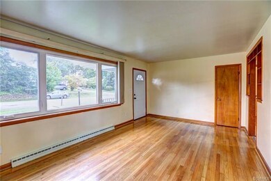Huge front picture window with sliding vertical blinds. Coat closet.