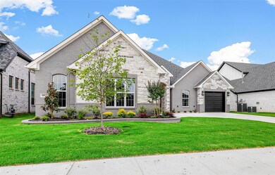 French country home featuring a front yard and a g