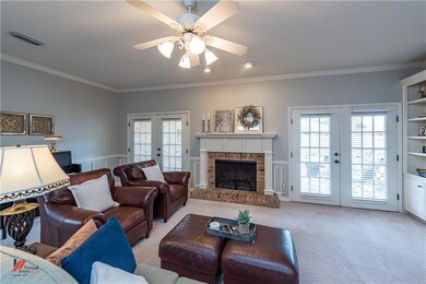 Double doors on both sides of the mantle lead out 