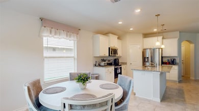 Dining space with arched walkways, recessed lighti