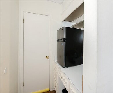 Kitchen with light countertops, freestanding refri