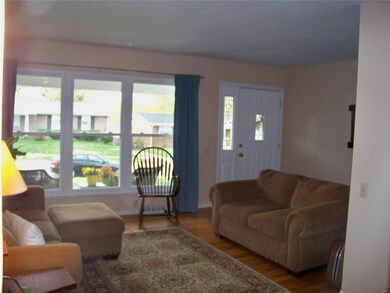 LIGHT BRIGHT DECOR WITH WINDOWS EVERYWHERE LETTING THE OUTSIDE IN AND BEAUTIFUL HARDWOOD FLOORS!