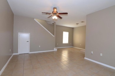Unfurnished room with a ceiling fan and light til