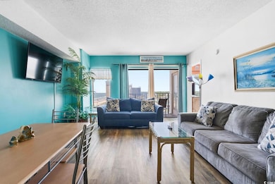 Living room with a textured ceiling and wood-type 