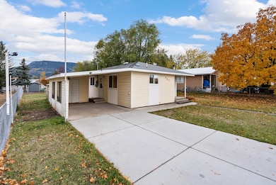 Attached carport and paved driveway, offering ample off-street parking