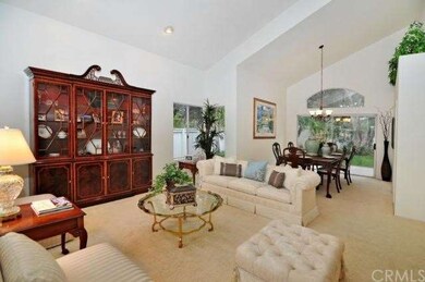 Formal living and dining room with dramatic vaulte