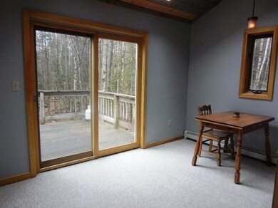 The dining area has vaulted ceiling with skylights and direct access to the deck