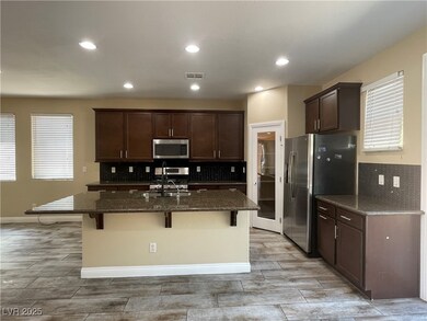 Kitchen with stainless steel appliances, backsplas