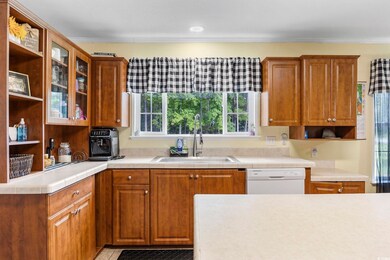 Kitchen with sink, light tile patterned flooring, 