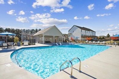 Community pool featuring a patio, a residential view, and grilling area