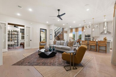 Living room with ceiling fan, stairway, recessed 