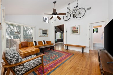 Living area with a ceiling fan, baseboards, light