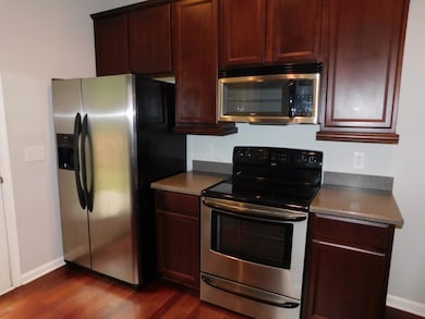 Kitchen featuring dark countertops, baseboards, ap