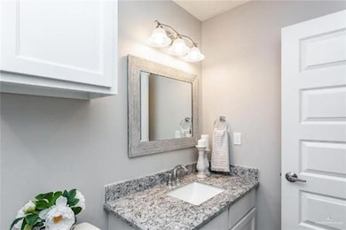 Half bathroom featuring vanity