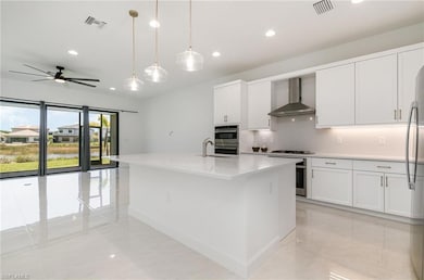Kitchen with wall chimney exhaust hood, recessed l