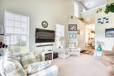 Living room featuring carpet floors and a high cei