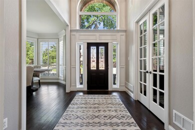 Entrance foyer featuring french doors and dark wood-type flooring