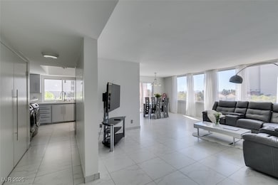 Living area with marble finish floor and washer /
